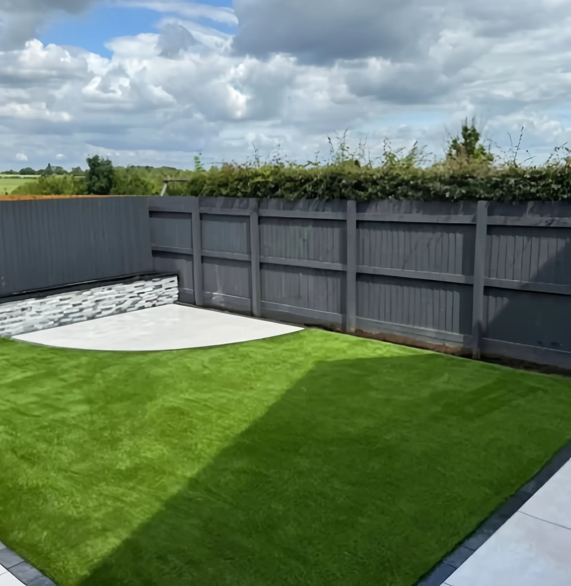 Artificial grass lawn with a porcelain patio edge