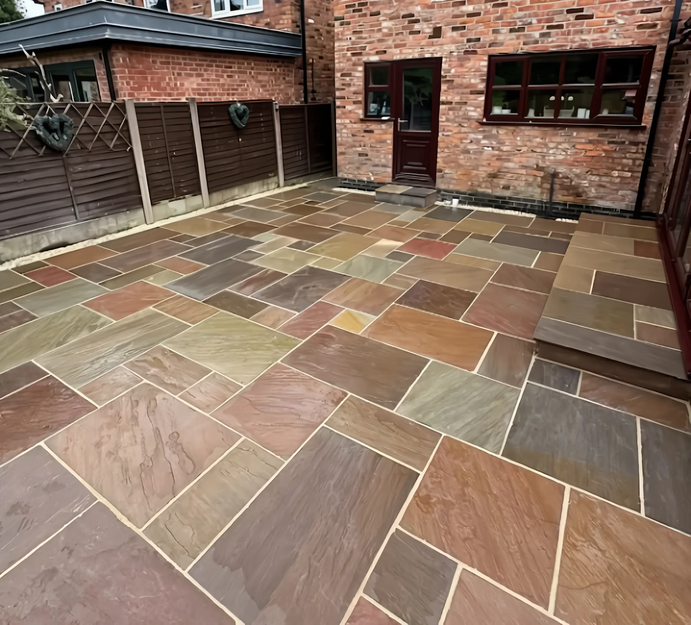 Multi-coloured Indian sandstone patio laid by Heritage in a Stirling garden