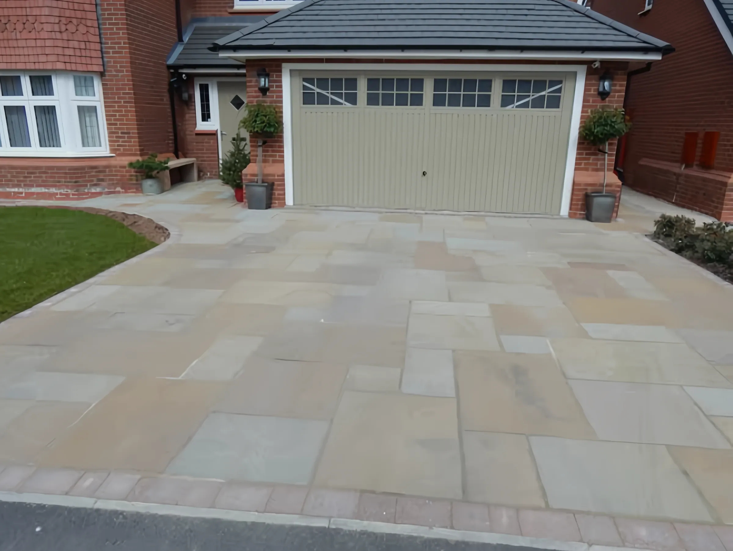 Indian sandstone driveway to a double garage