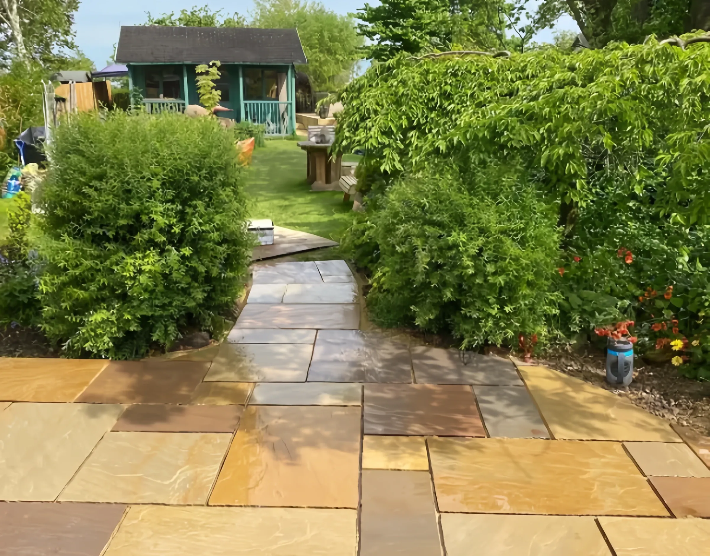 Indian sandstone path winding to a summerhouse, landscaped by Heritage