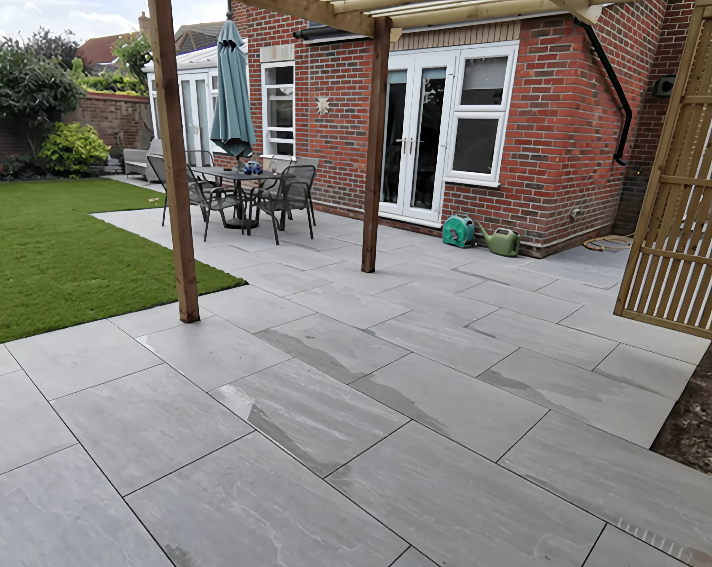 Grey porcelain patio outside French doors, built by Heritage