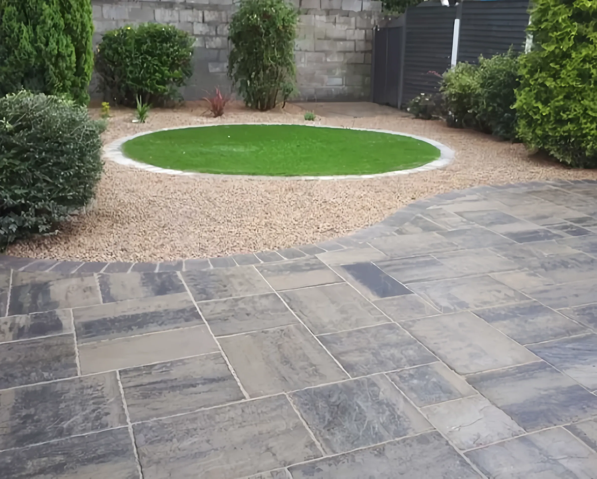 Circular lawn feature set into riven paving by Heritage in a Stirling garden